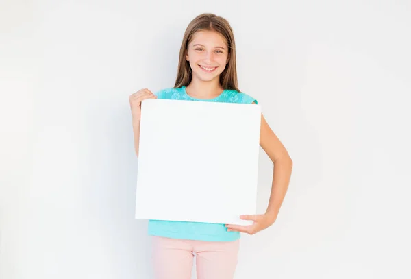 Teen girl holding blank canvas — Stock Photo, Image