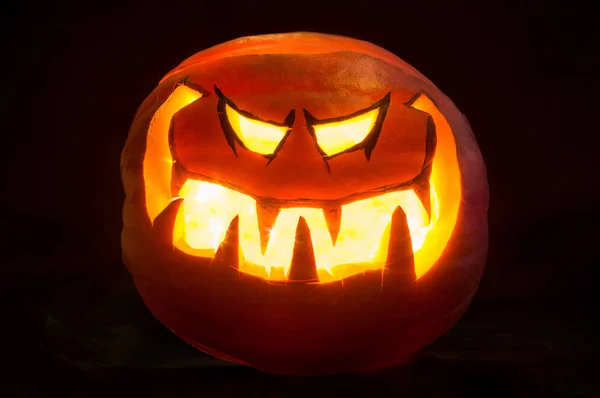 Sonrisa de calabaza de Halloween y ojos rasgados para la noche de fiesta. Fondo negro — Foto de Stock