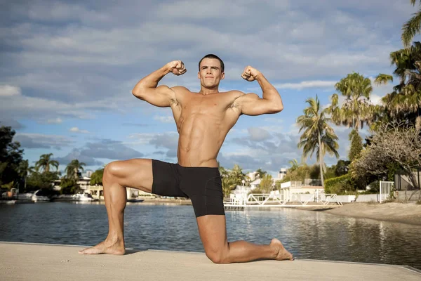 Homem forte exercitando na praia — Fotografia de Stock