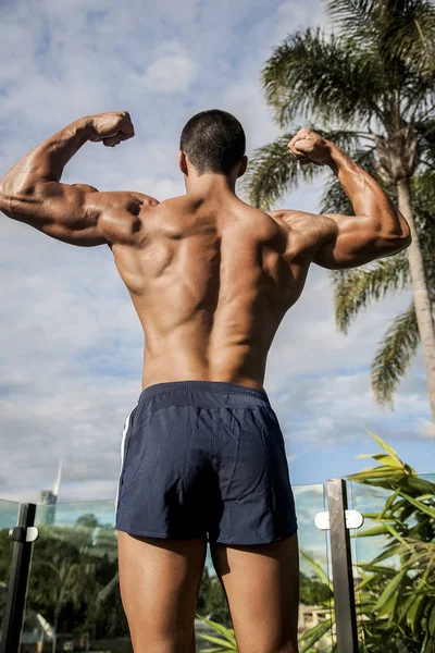 Strong man standing with hands up — Stock Photo, Image