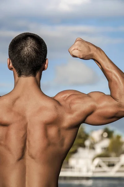 Body builder showing his right arm