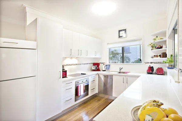 Neat clean fresh white fitted kitchen