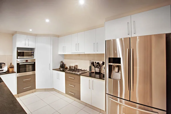 Pantry cupboard and fridge near oven — Stock Photo, Image