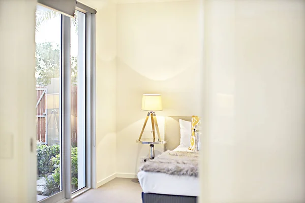 Mirando a la entrada del dormitorio moderno con una lámpara amarilla — Foto de Stock