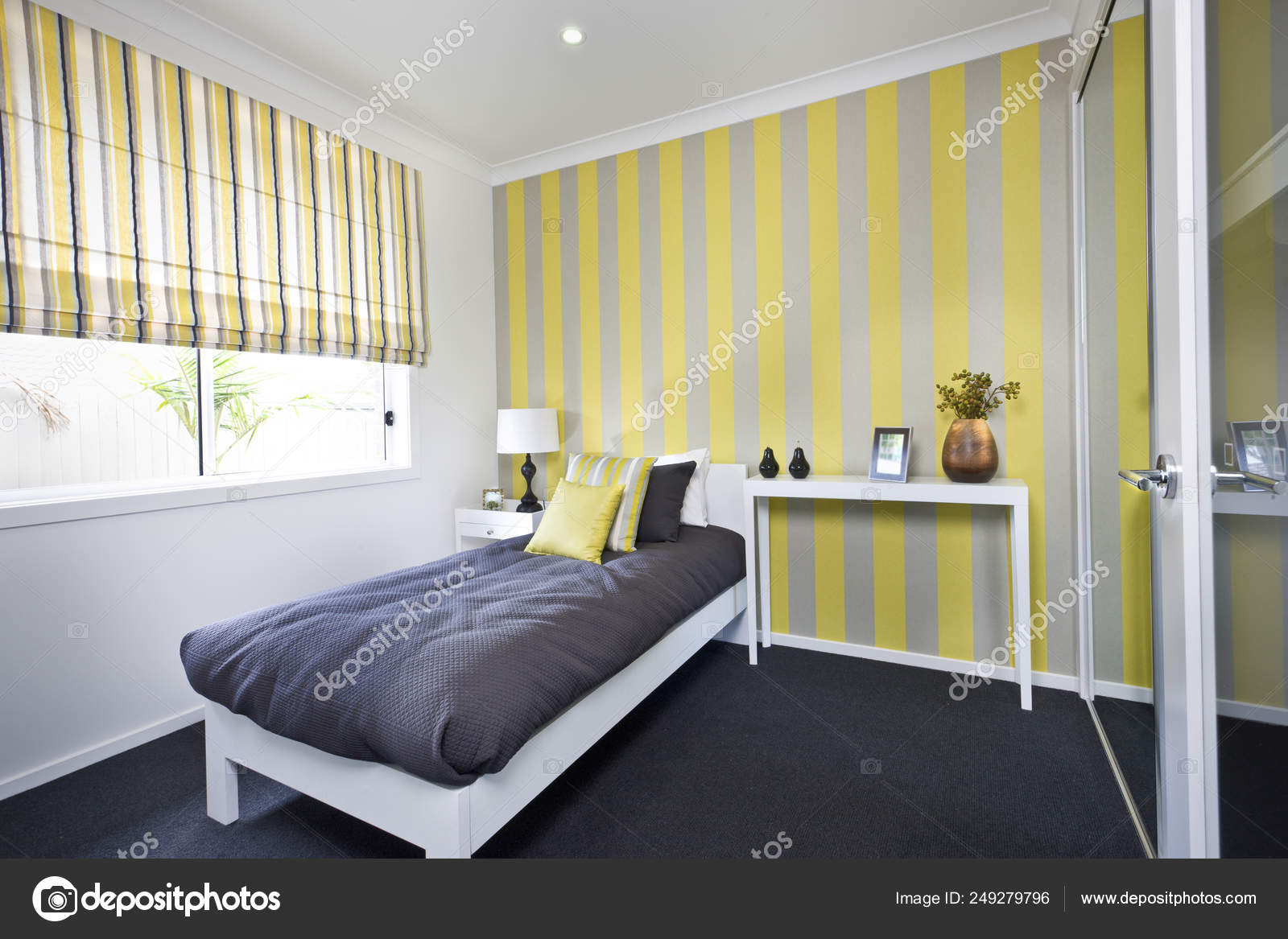Classic bedroom with a small bed and pillows beside windows