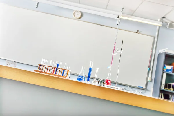 Artículos científicos en un laboratorio con vasos de precipitados y tubos — Foto de Stock