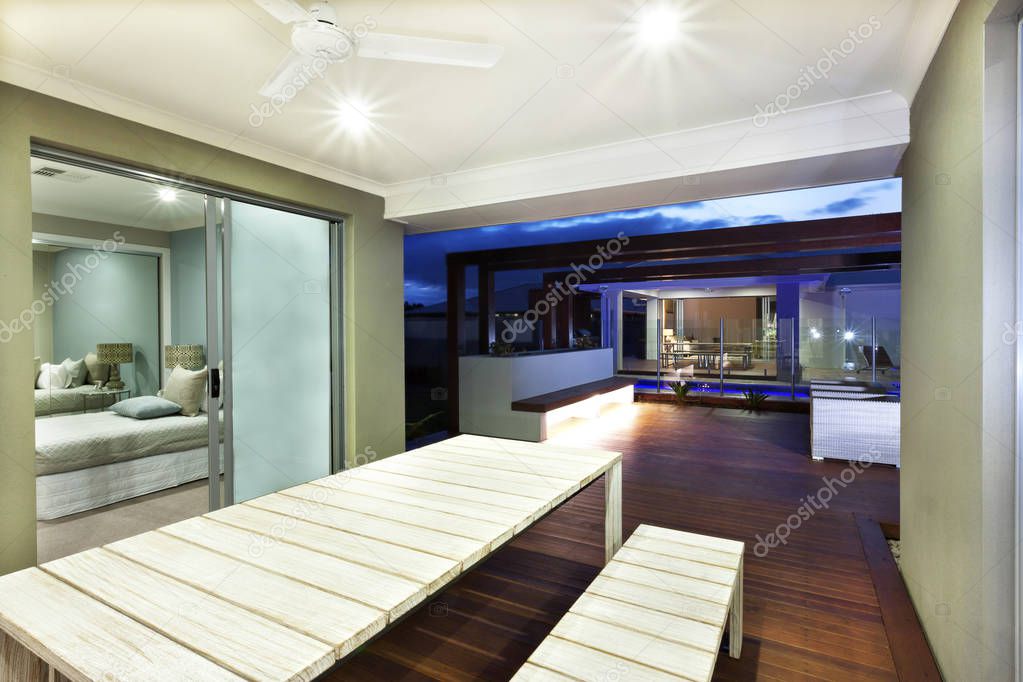 Interior lighting of a house with patio area at night