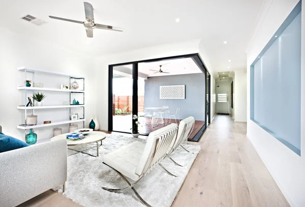 Modern living room and patio area through the hallway