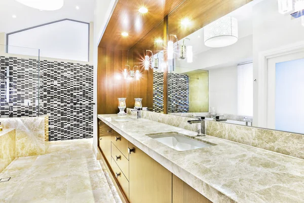 Modern tiled table in wash room with sink.