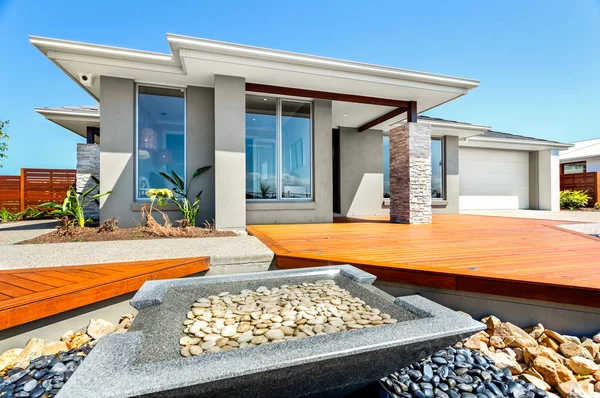 Big house and garden filled with stones — Stock Photo, Image