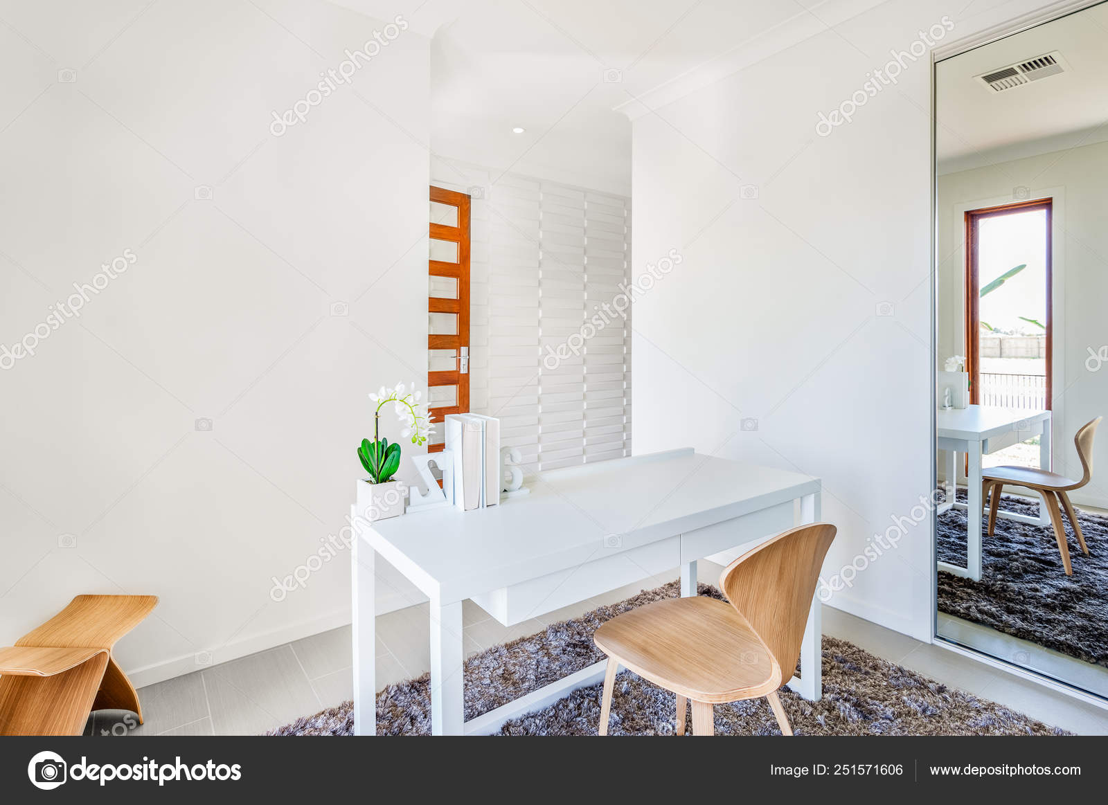 A Workroom With White Walls And A Table With Simple