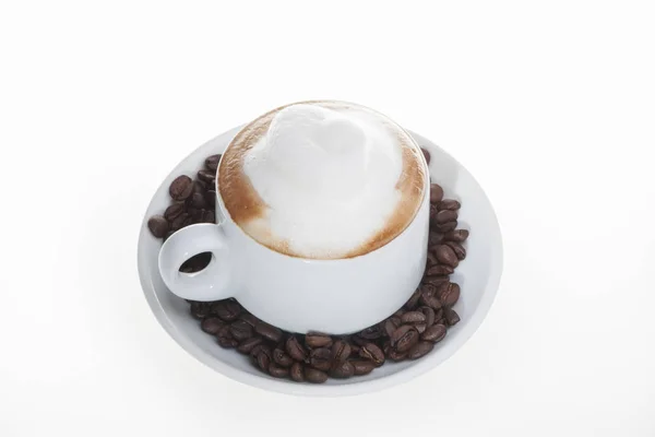 White mug with coffee beans and plate — Stock Photo, Image