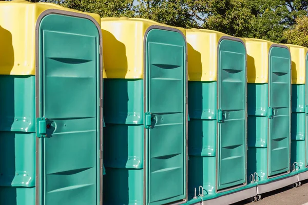 A row of green mobile toilet cabin Stock Picture