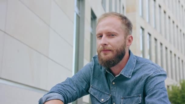 Man with Beard Sitting in Town — Stock Video