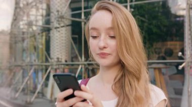 Genç Redhead kasabada bir telefonu kullanarak Lady