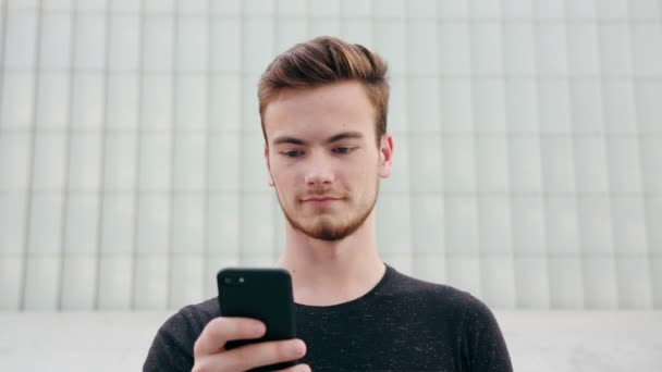 Homem com barba usando um telefone na cidade — Vídeo de Stock