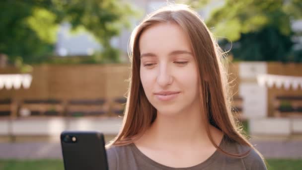 Jeune femme utilisant un téléphone en ville — Video