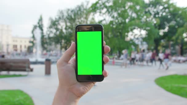 A Hand Holding a Phone with a Green Screen — Stock Video