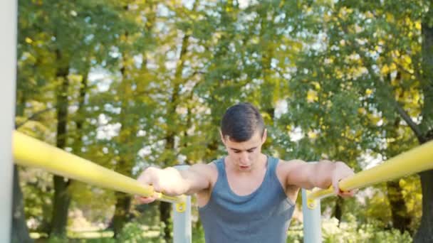 Male Athlete Exercise on Gymnastic Parallel Bars — Stock Video