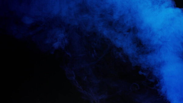 Blue bomb smoke on black background