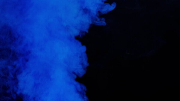 Blue bomb smoke on black background