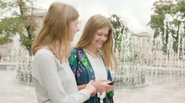 Genç bayanlar kasabada bir telefon kullanma