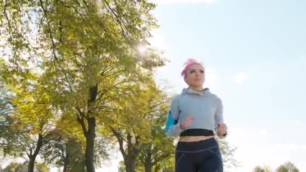 Young Lady with Pink Hair Jogging in the Forest — Stock Video