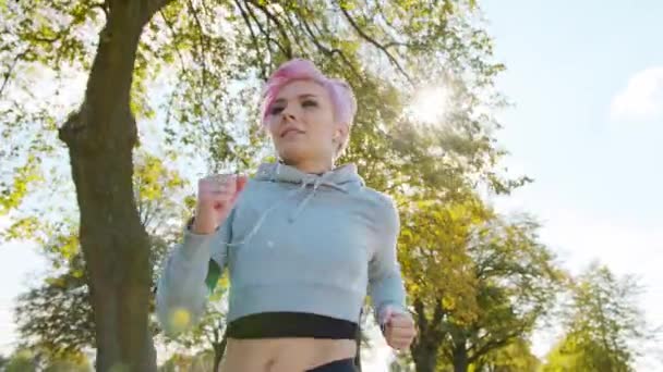 Young Lady with Pink Hair Jogging in the Suburbs. Glitch — Stock Video