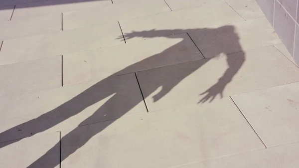 Young Womans Shadow Dancing Outside