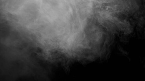 White clouds of vapor smoke are isolated on a black background. Gas explodes, swirl and dances in space. A magic fog dust texture effect that can be used by overlay and changing their transparency.