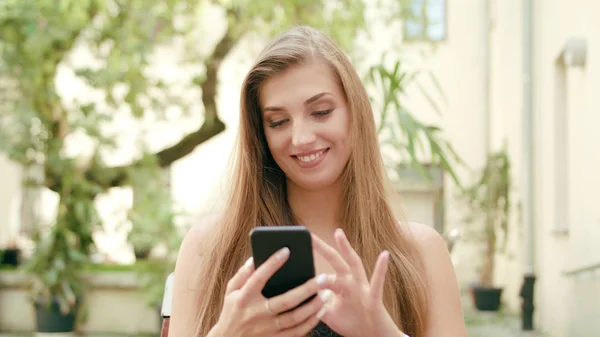 Young Lady Using a Phone in Town — Stock Photo, Image