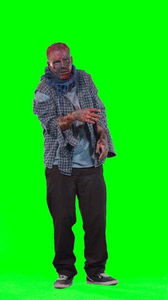 Scary zombie in halloween isolated green background — Stock Photo, Image
