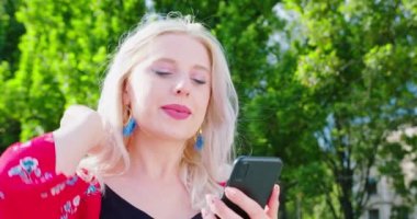 Beatiful Lady Using a Phone Outdoors