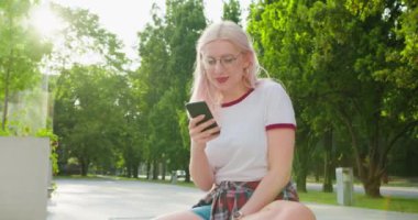 Beatiful Lady Using a Phone Outdoors