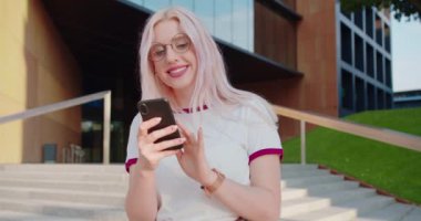 Beatiful Lady Using a Phone Outdoors