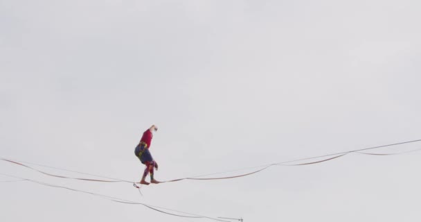 Young Acrobat Walking on Tightrope Outdoors — Stock Video