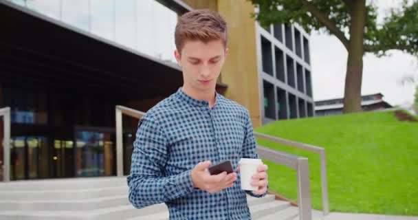 Young Man Using a Phone Outdoors — Stock Video