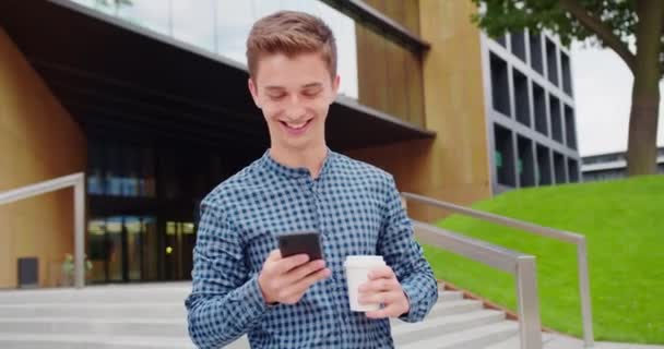 Young Man Using a Phone Outdoors — Stock Video