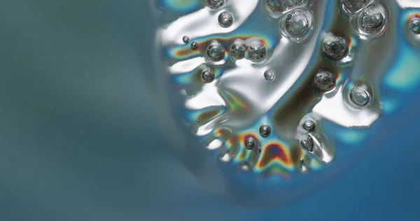 Melting Plastic Bubbles. Iridescent plastic surface melting, warping, and boiling.