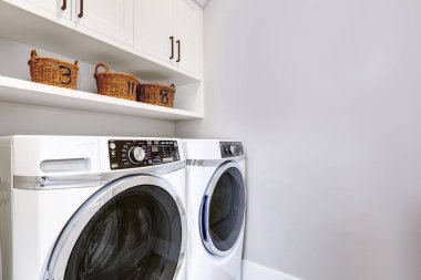 White clean laundry room modern with washer and dryer clipart