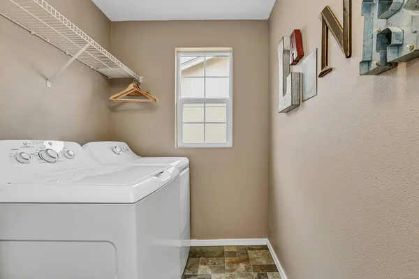 Laundry room interior with washer and dryer .