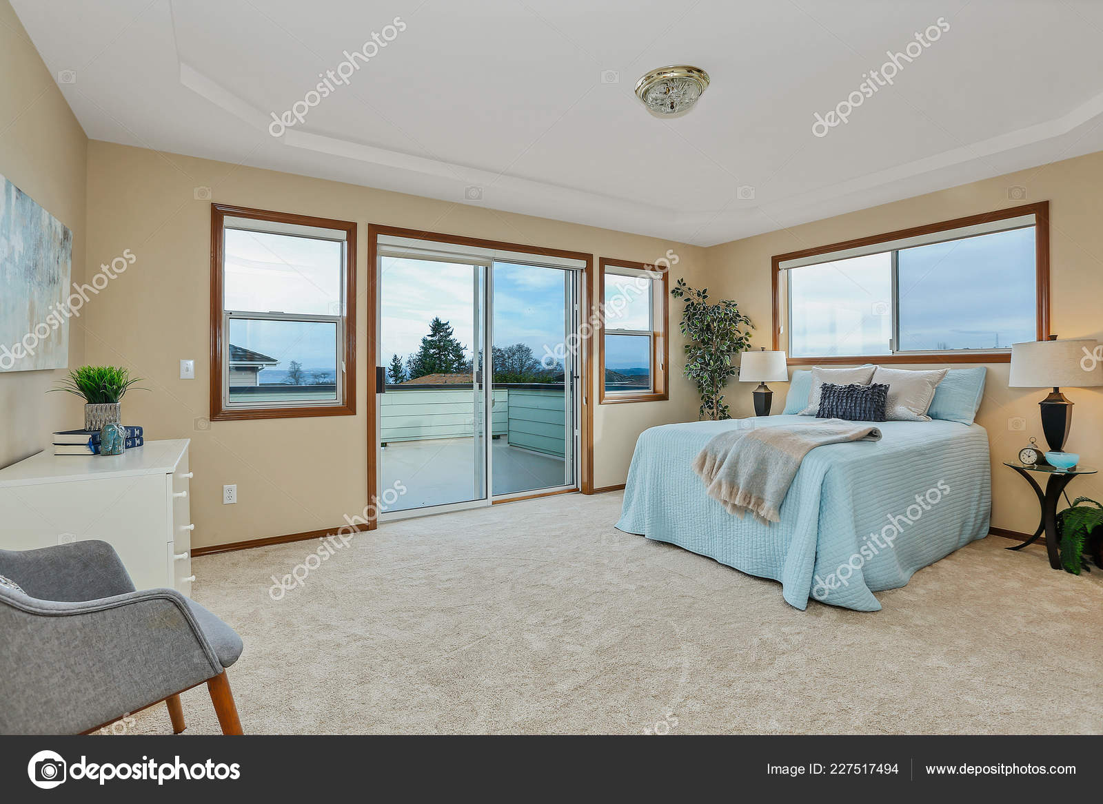 Large Beige Master Bedroom Blue Bedding Stock Photo
