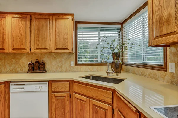 Open large kitchen interior with vaulted ceiling and white appliances from ninetees.