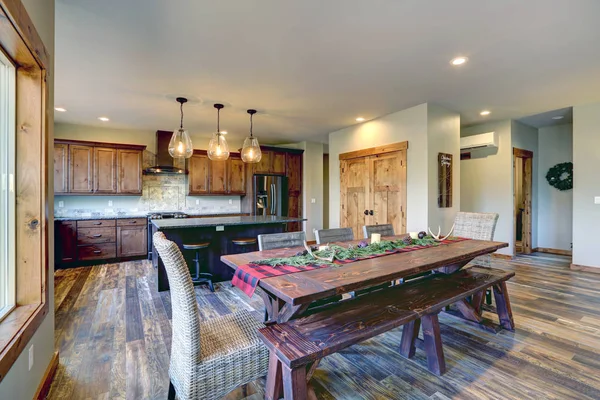 Reclaimed wood trestle dining table decorated for Christmas in a luxury American country house.