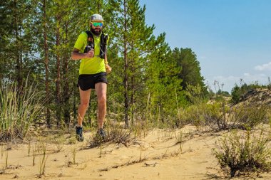 Atlet vahşi doğada off-road çalışıyor. Çöl yolu koşu