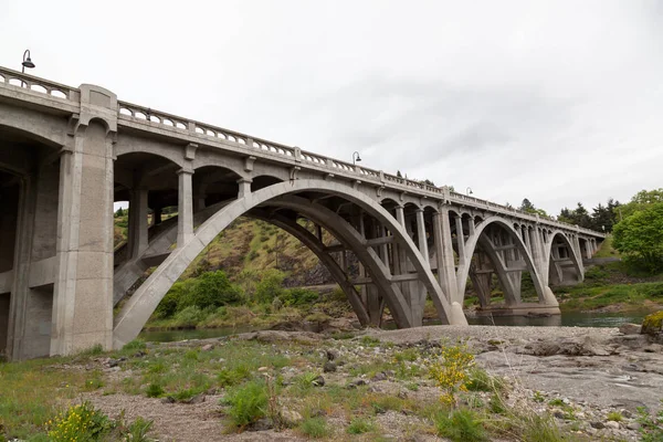 オレゴン州の南アムプクオー川の緑の水にまたがるコンクリート アーチ橋 — ストック写真