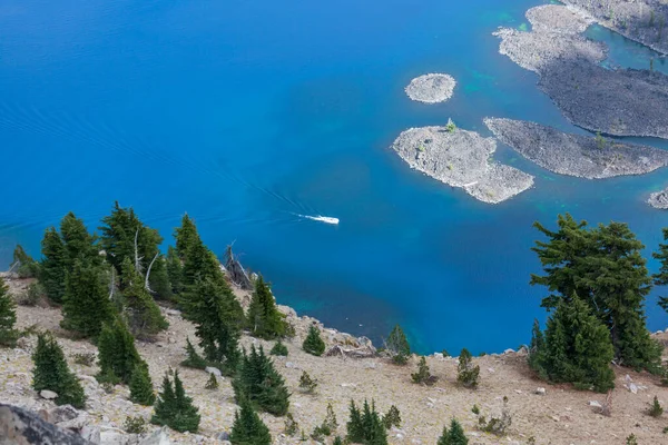 Bir tur teknesi, Güney Oregon Şelale Dağları 'ndaki muhteşem mavi ve derin Krater Gölü' nde insanları gezdiriyor..