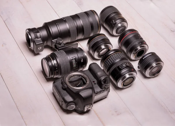 Camera lenses on wooden background — Stock Photo, Image