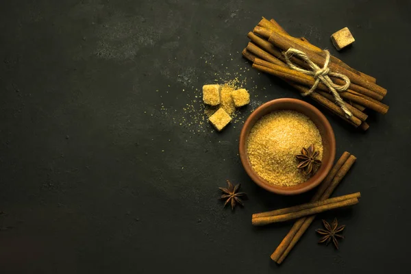 Cinnamon on dark table — Stock Photo, Image