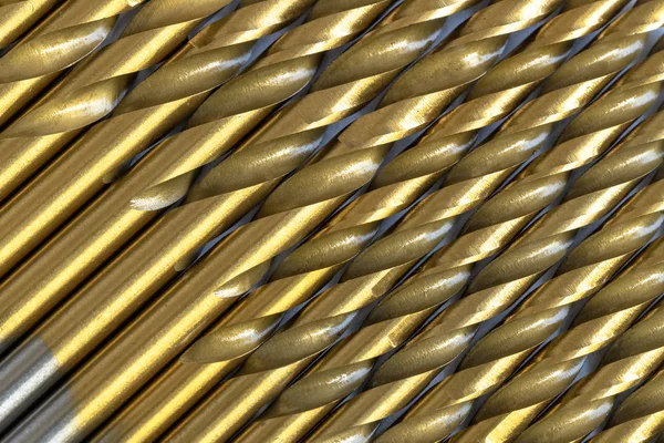 Twist drill bits aligned diagonally forming a pattern. Full frame image